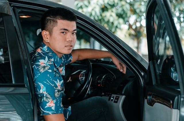 man sitting in car